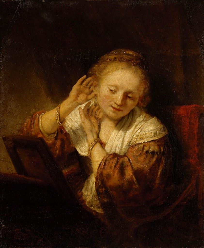 REMBRANDT Harmensz. van Rijn Dutch 1606-69 Young woman trying on earrings 1657.