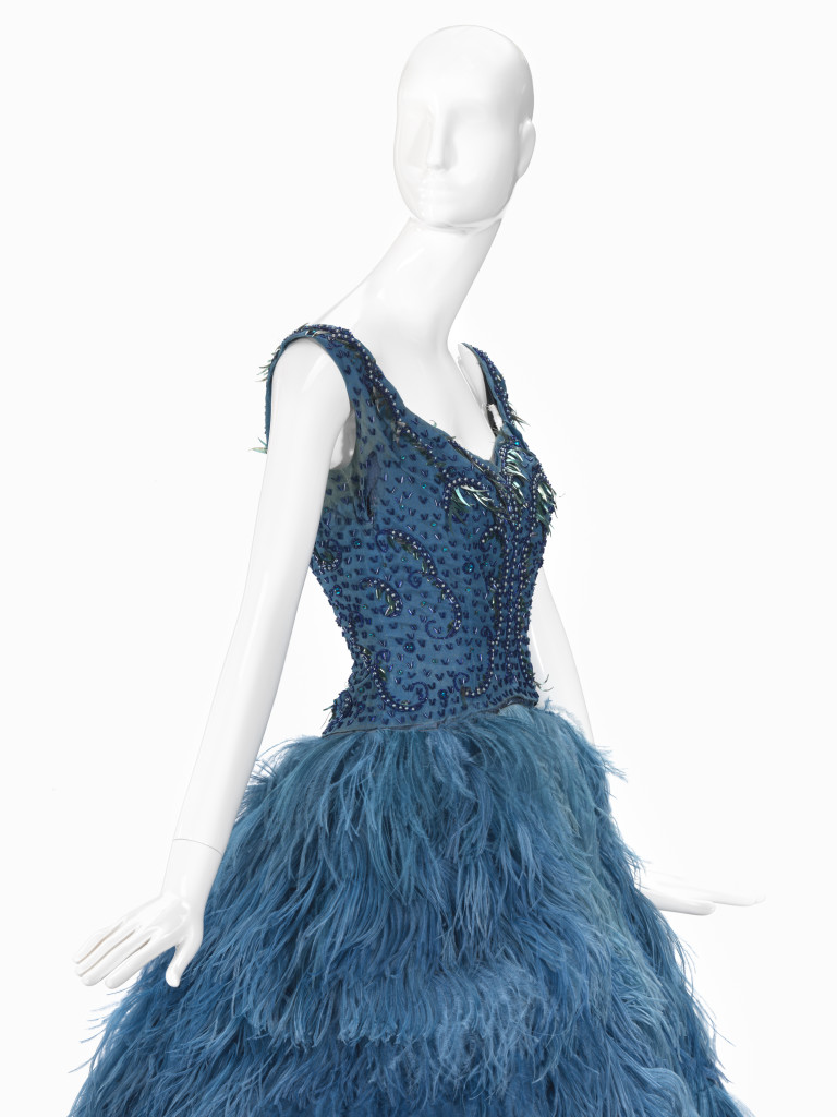 LA PETITE, Melbourne (fashion house); Pat ROGERS (designer)Evening dress (c. 1959) (detail)silk (organza), silk (taffeta), feathers (ostrich), cotton (tulle), glass (bugle beads), (diamentés), acetate (sequins)(a) 23.0 cm (centre back) 28.5 cm (waist, flat) (bodice) (b) 109.0 cm (centre back) 39.4 cm (waist, flat) (skirt)National Gallery of Victoria, MelbourneGift of Annette Taylor (née Klooger), 20122012.270.a-b