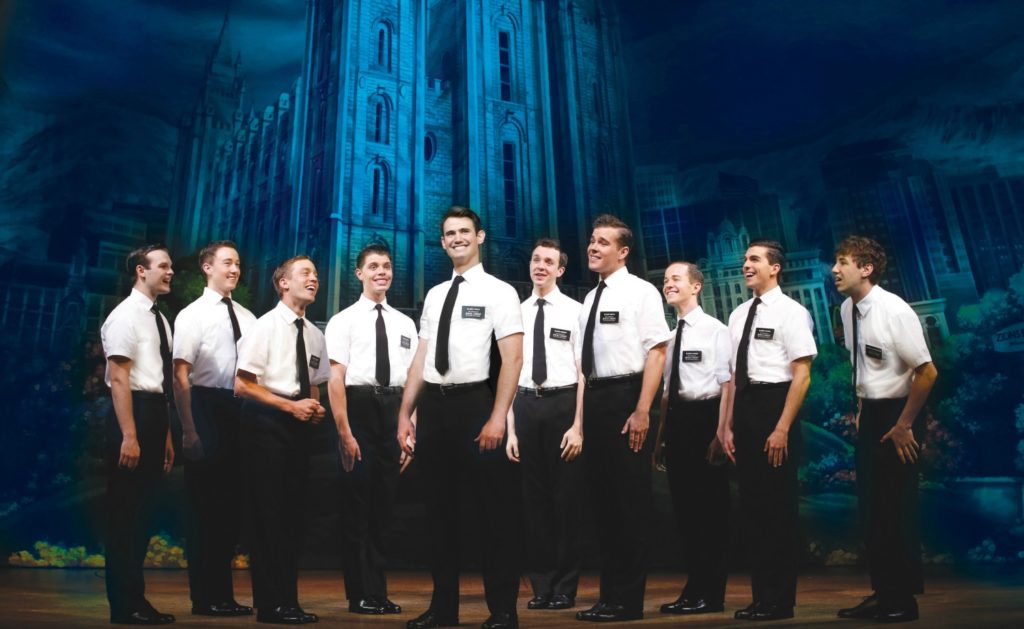 Ryan Bondy, centre, as Elder Price, A.J. Holmes, far right, as Elder Cunningham and company. © Jeff Busby